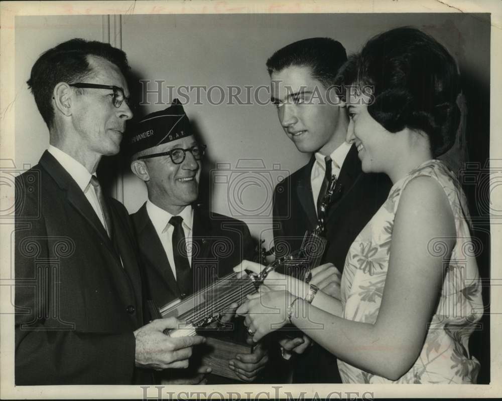 1964 Press Photo John J Mooney, National Savings Bank, presents trophies to kids