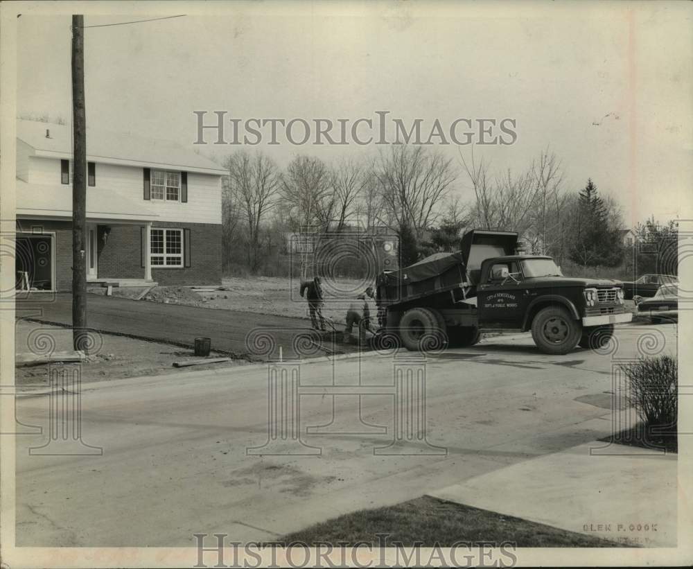 1967 Press Photo Crew paves driveway for home in Rensselaer, New York