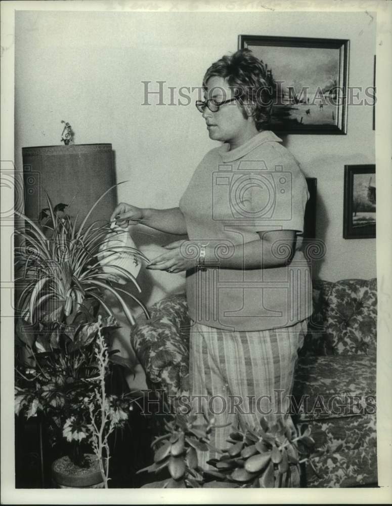 Load image into Gallery viewer, 1973 Press Photo Linda Leventhal watering plants in her New York home
