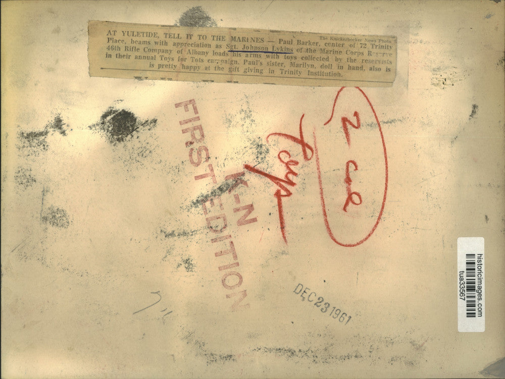 1961 Press Photo US Marine Reservist delivers donated toys to Albany, NY child