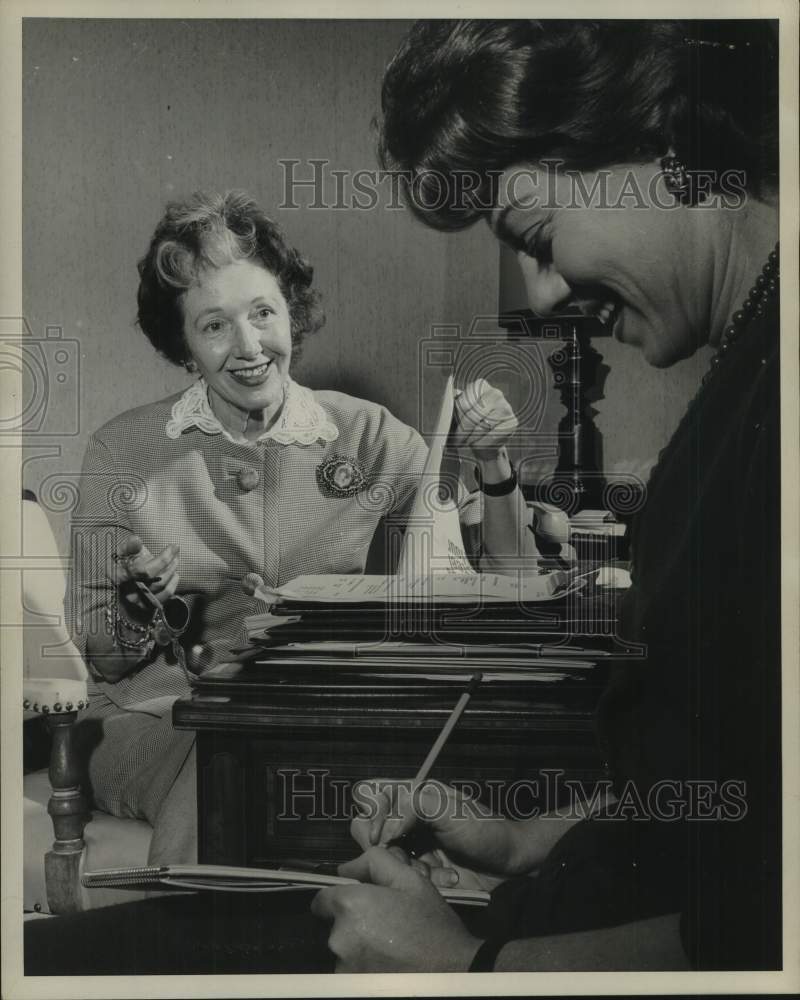 1961 Press Photo Armina Marshall, TV producer, talks with another woman writing