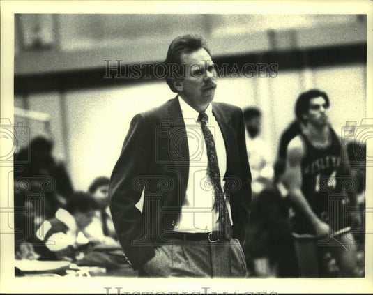 Press Photo Basketball coach looks on as player