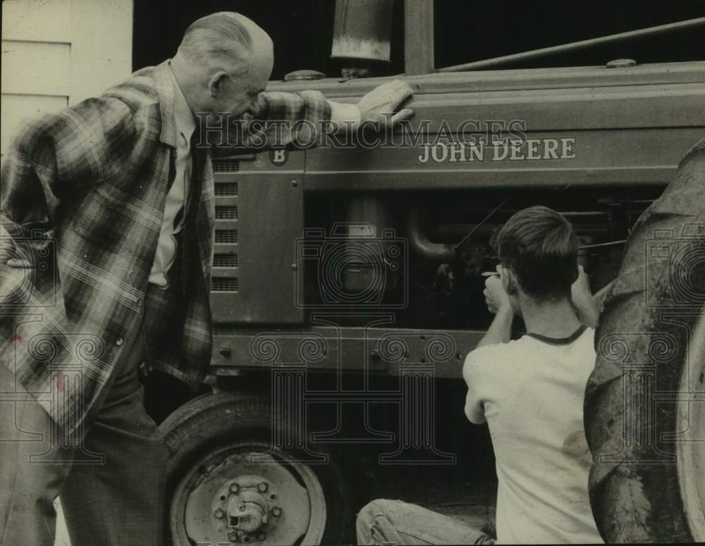 1962 Press Photo US Congressman Ernest Wharton (NY) watches man service tractor