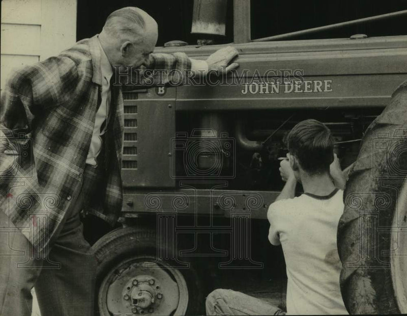 Load image into Gallery viewer, 1962 Press Photo US Congressman Ernest Wharton (NY) watches man service tractor
