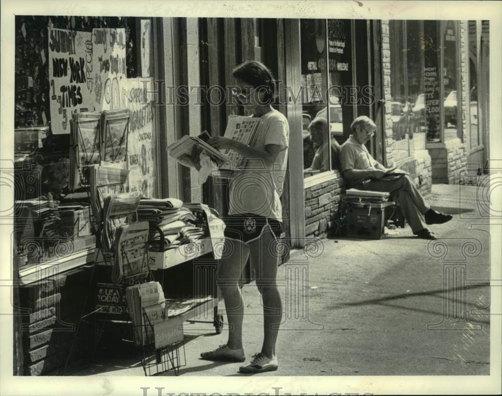 1983 Press Photo Jane Zacek scans newspaper outside Albany, New York card shop- Historic Images