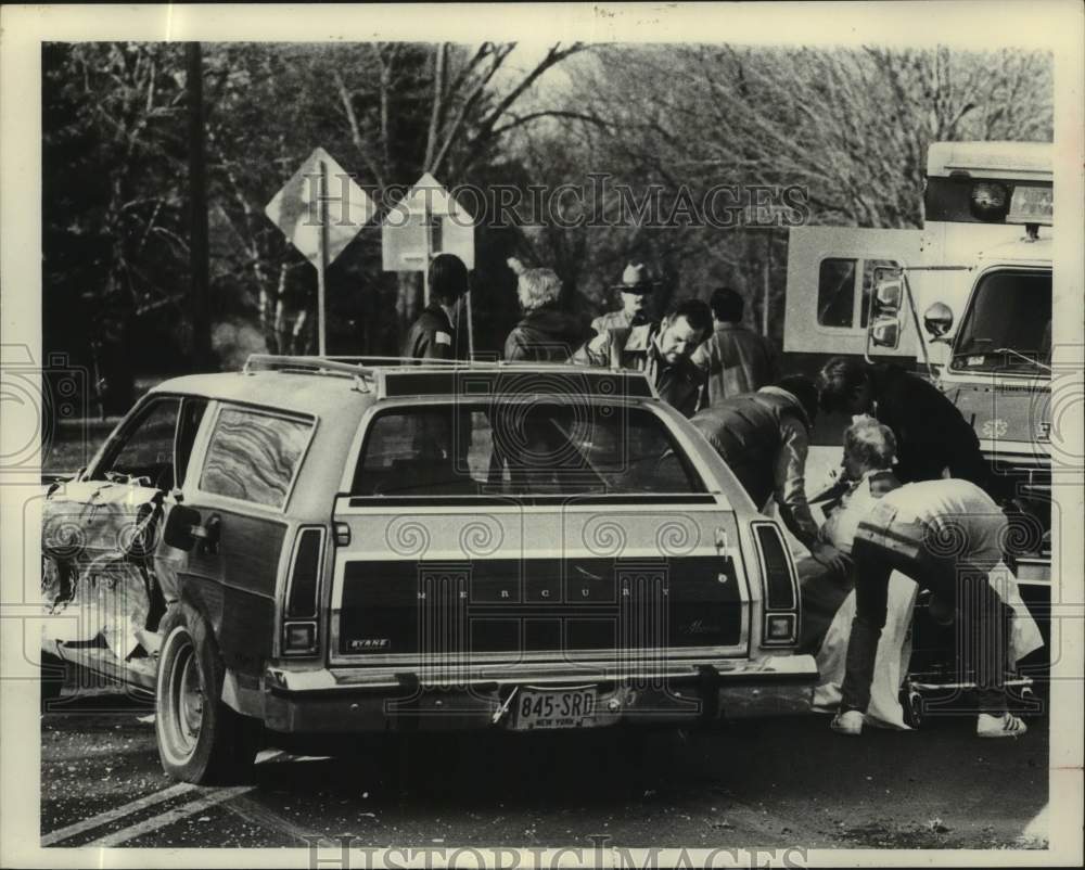 Press Photo Crew attends to auto accident victim in New York - tua37152- Historic Images