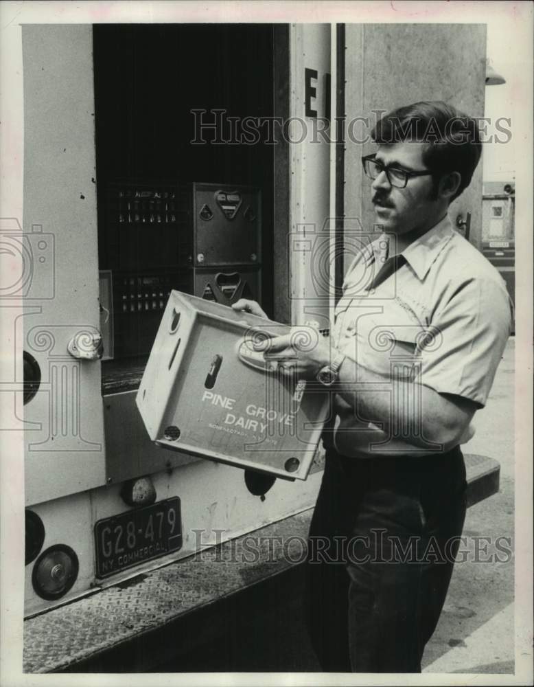 Load image into Gallery viewer, 1973 Press Photo Chuck Harwood unloads milk from truck in New York - tua39516
