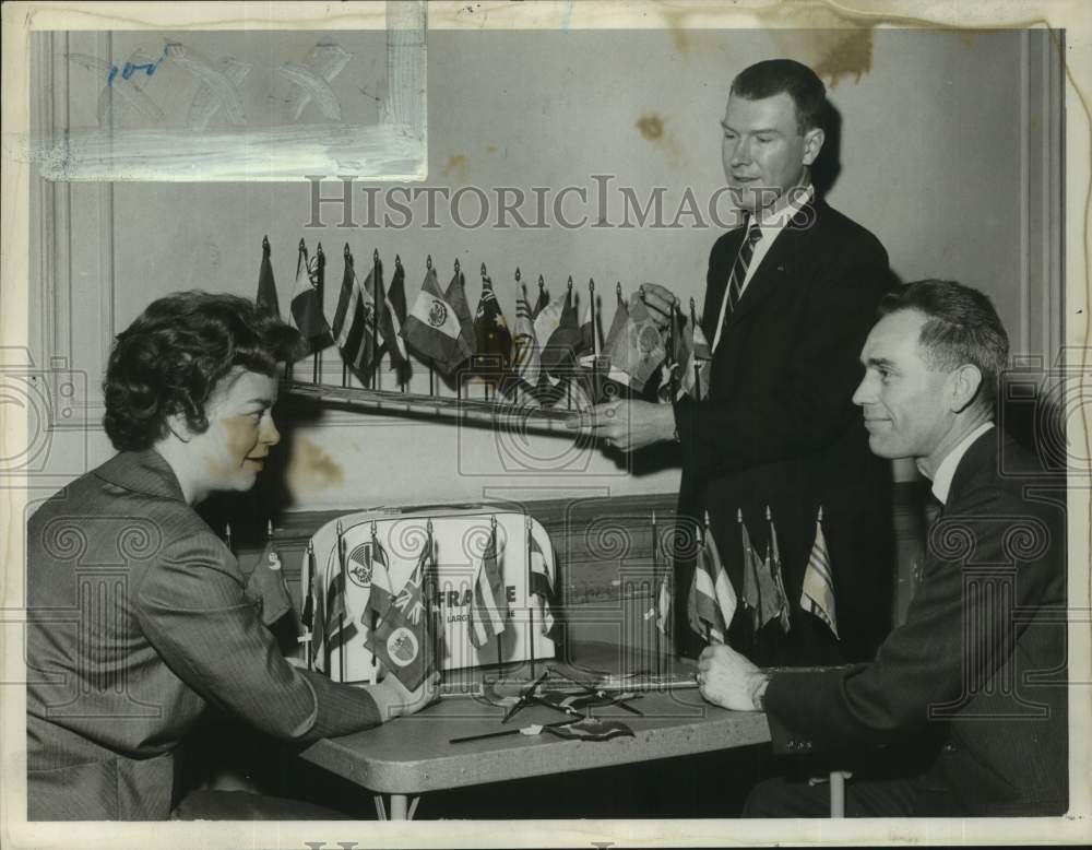 1961 Press Photo Group prepares display of international flags in New York- Historic Images