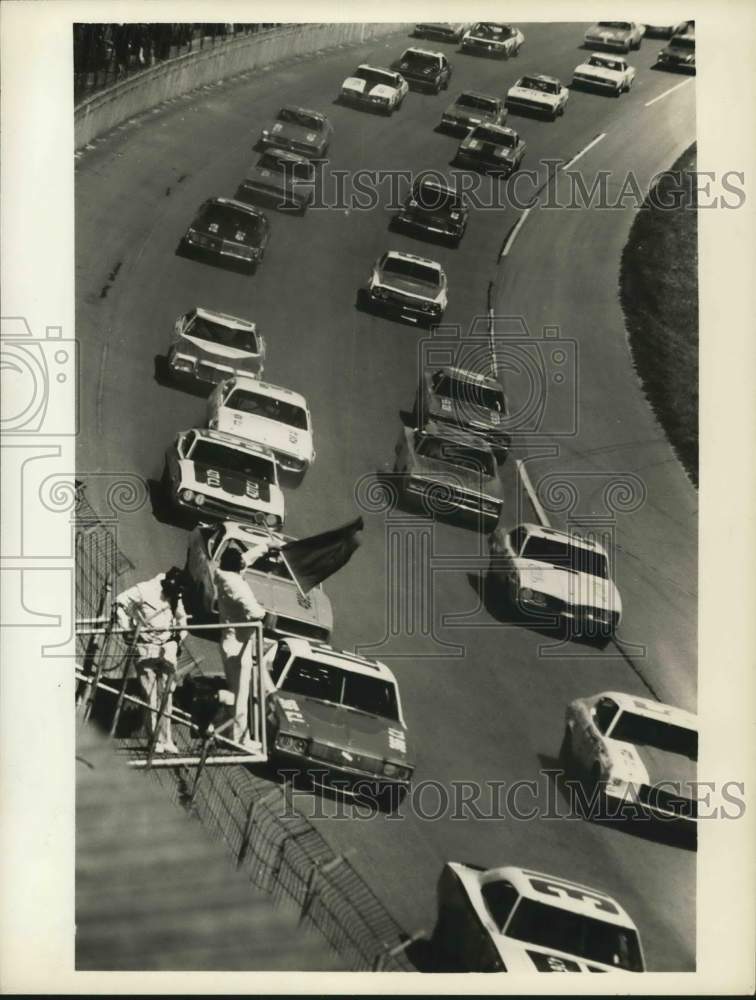 Press Photo Stock cars pass starter on race track - tua53362- Historic Images