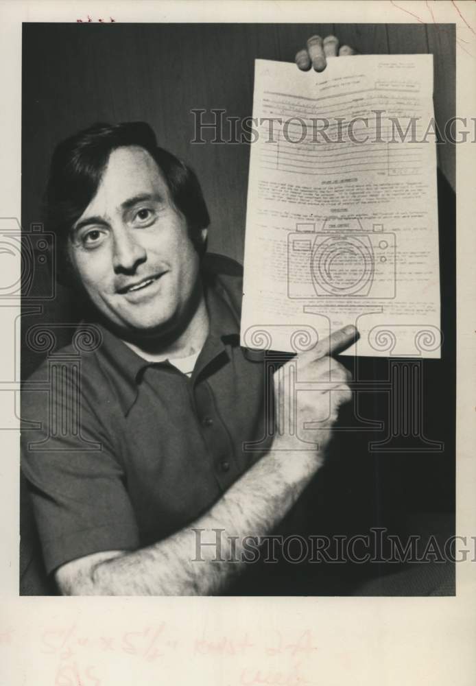 1974 Press Photo Warren Klein shows off legal document in New York - tua56593