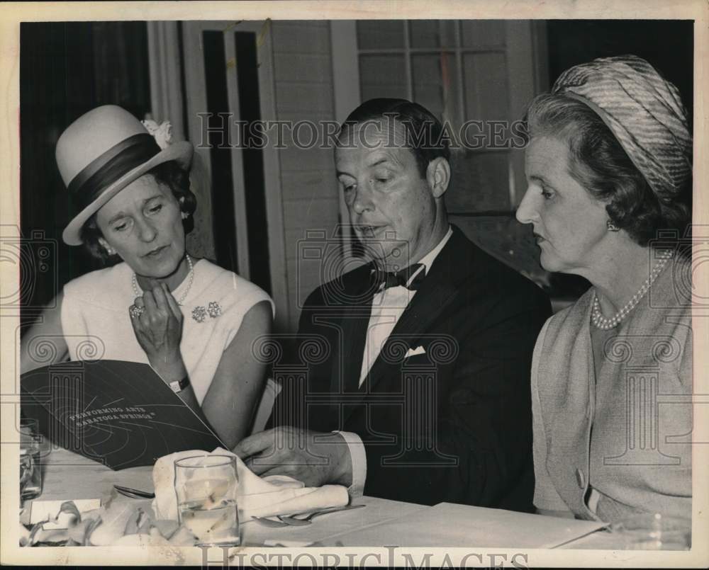 1963 Press Photo Group looks over brochure during luncheon in Saratoga, New York