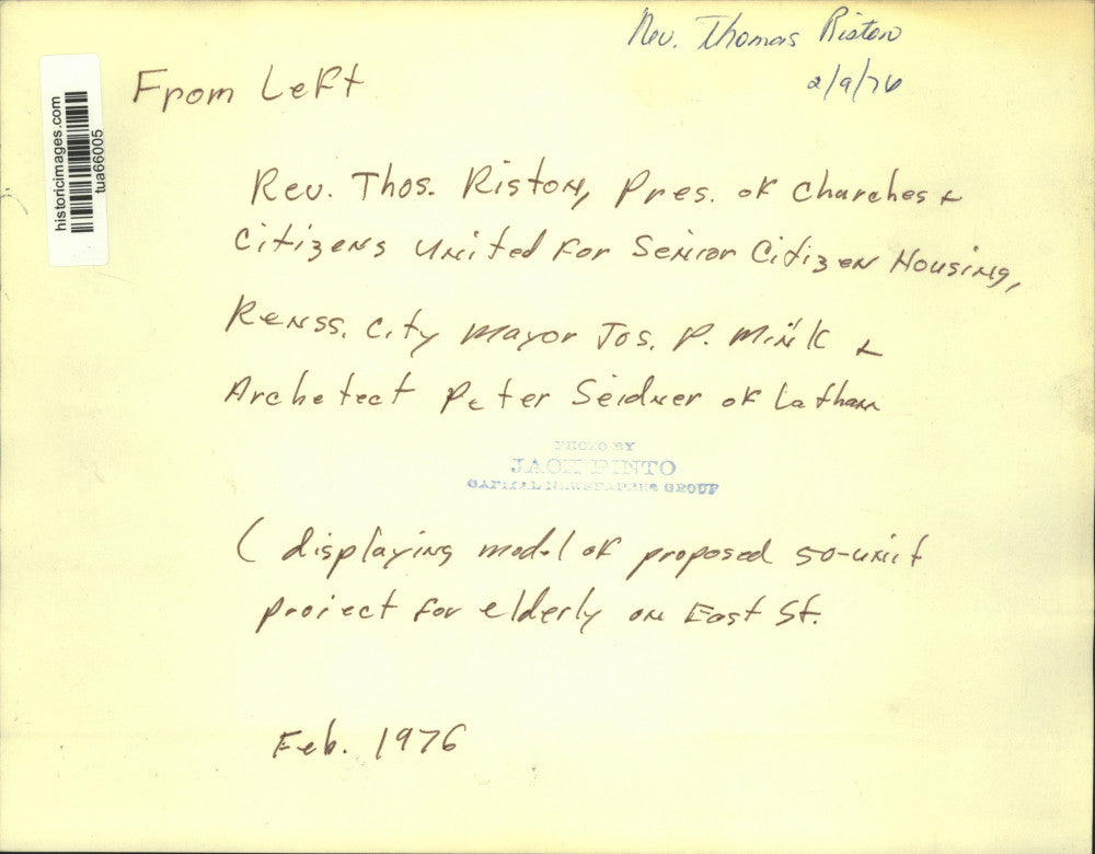 1976 Press Photo Officials study model of proposed housing unit in New York