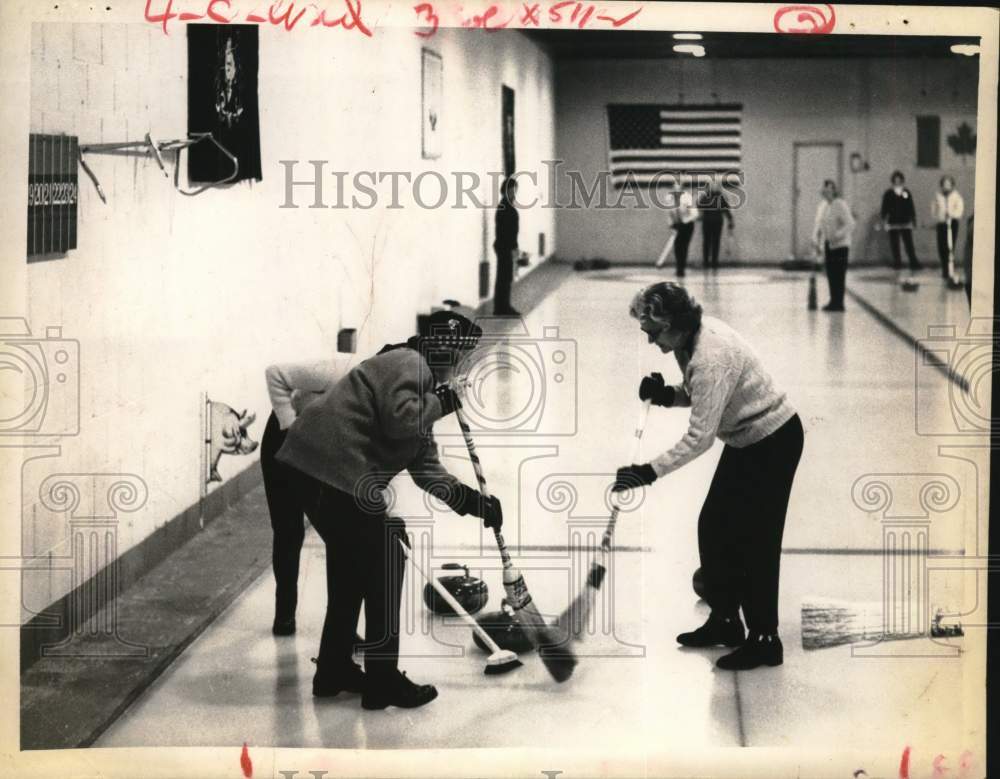 1966 Press Photo Curling team members sweep ice during match in Albany, New York- Historic Images