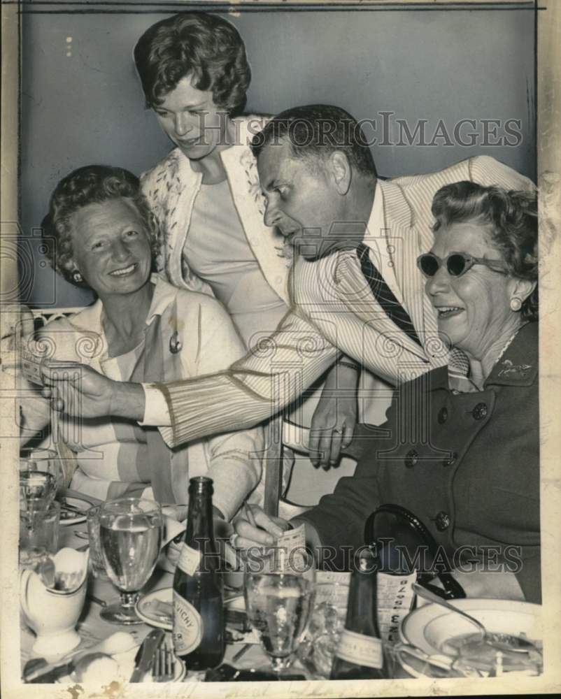 1964 Press Photo Track official examines betting ticket in Saratoga, New York- Historic Images