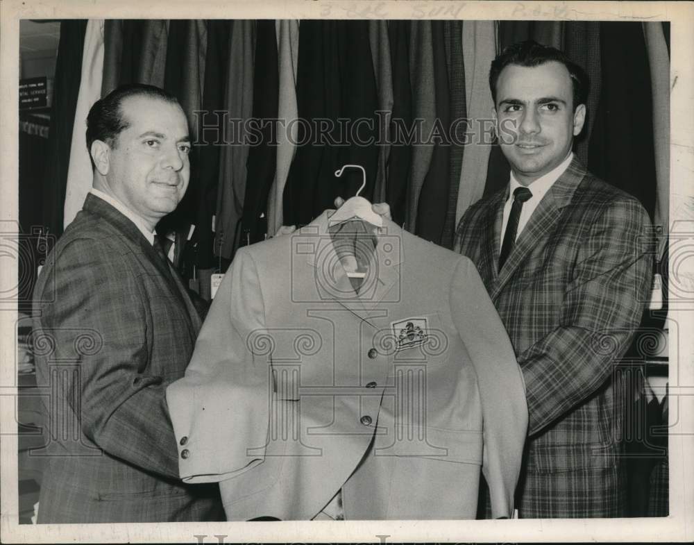 1963 Press Photo Menswear store owners hold up blazer in Albany, New York