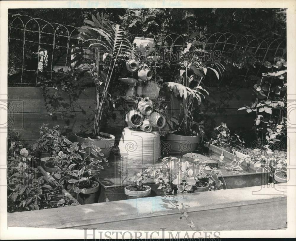 1961 Press Photo Fountain and plants in New York garden - tua97359- Historic Images