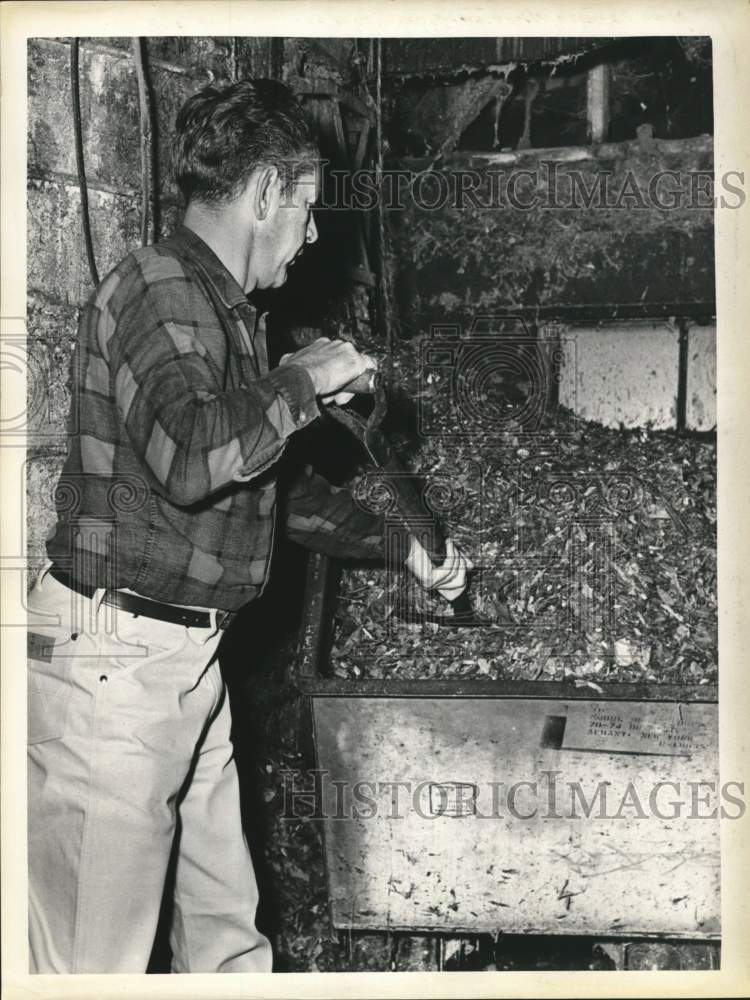 Press Photo Carl Hoffman shoveling material in bin on his New York farm- Historic Images