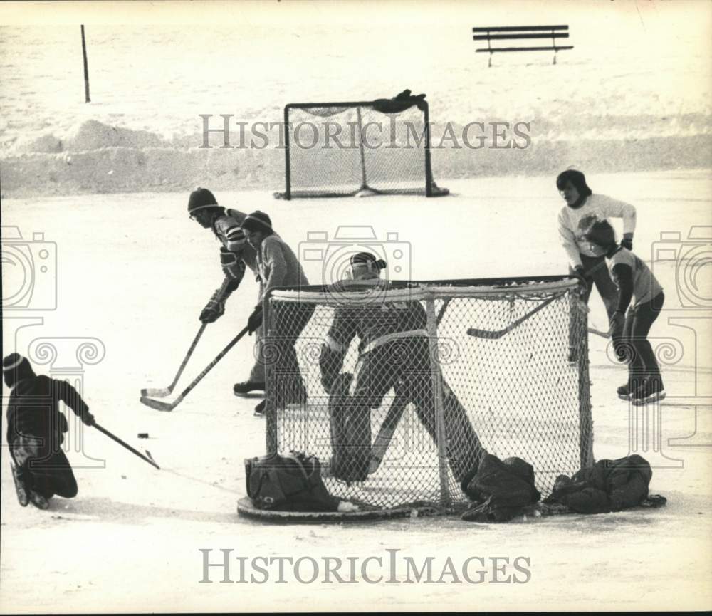 1977 Press Photo Kids playing hockey on Van Schaick Pond in Cohoes, New York- Historic Images