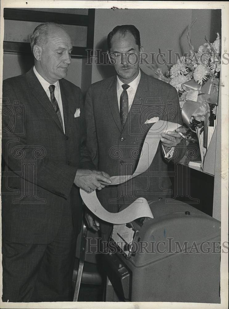 Load image into Gallery viewer, 1962 Press Photo Brokers Warner Cosgrove Jr and J Erwin Hyney examine stock tape
