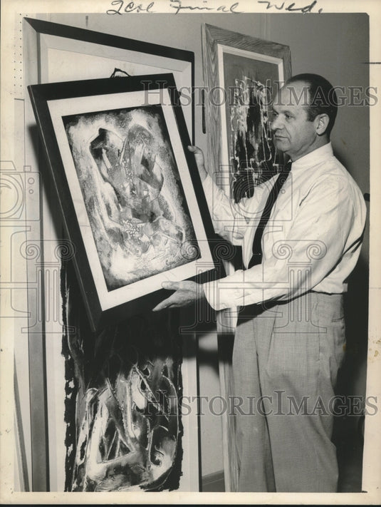 1961 Press Photo Eugene Winters examines a framed painting - tup01953- Historic Images