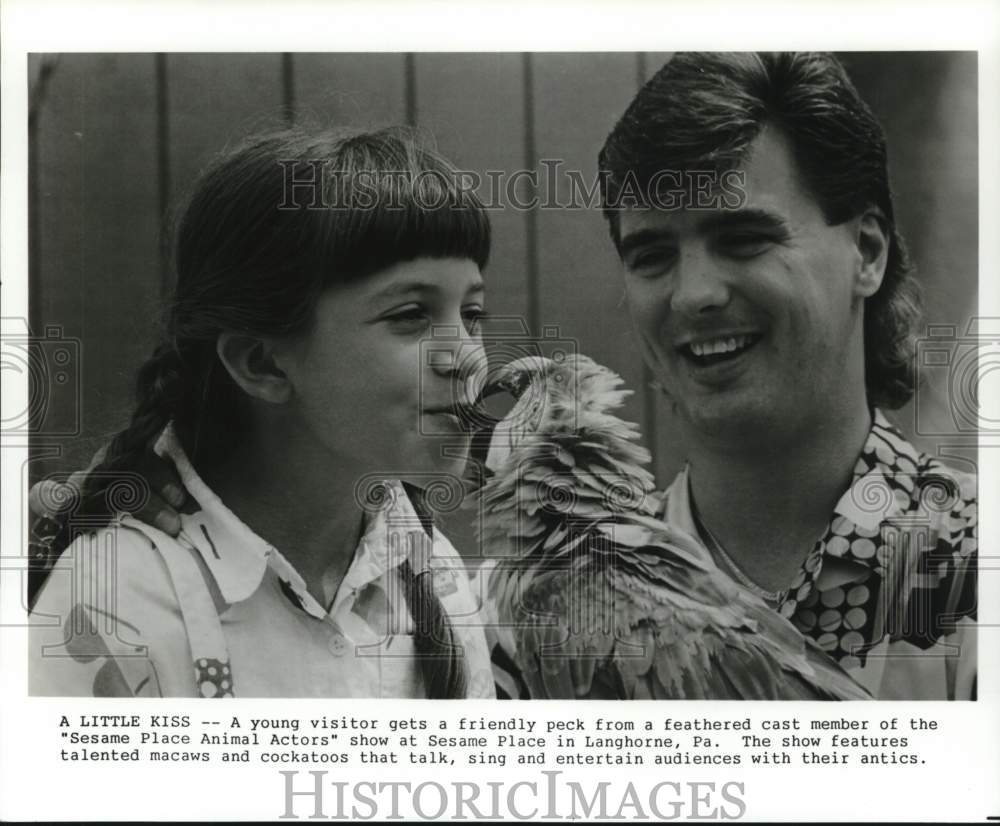 1989 Press Photo Visitor and trainer with bird at Sesame Place in Pennsylvania