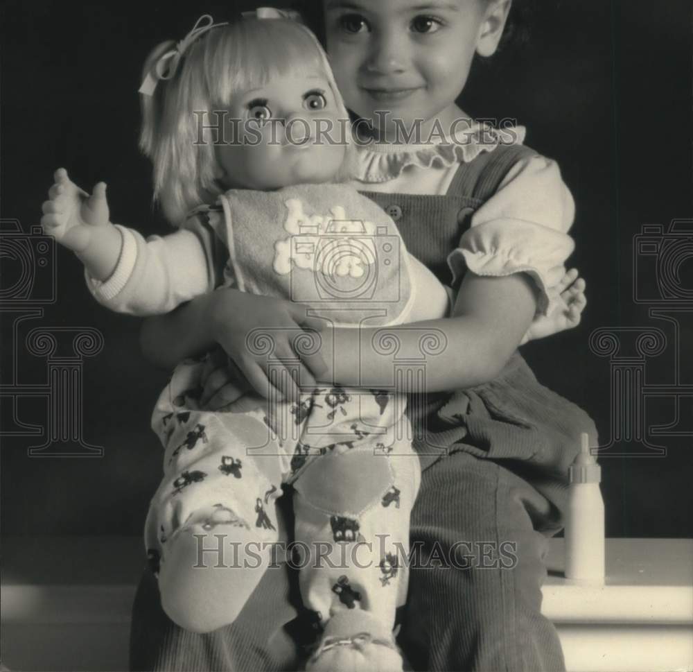 Press Photo Girl with Baby Talk Doll - tup26640- Historic Images