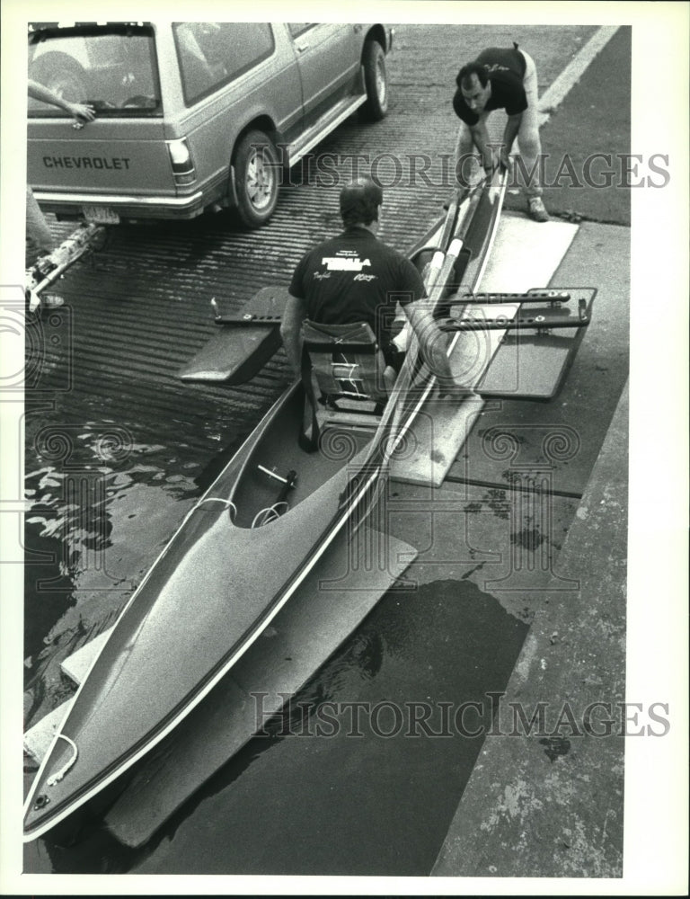 1989 Press Photo Man helps rower launch boat in Albany, New York - tus00176- Historic Images