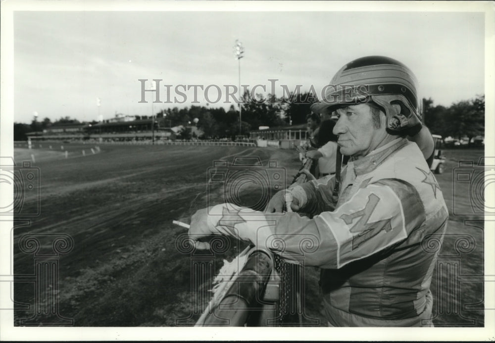 Press Photo Jockey J.P. Morel takes a break along the rail in Saratoga, New York- Historic Images