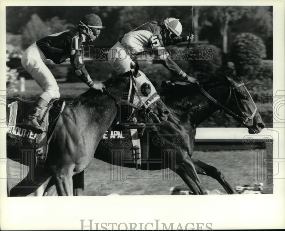 1987 Press Photo Jockeys cross the finish line during race in Saratoga, New York- Historic Images