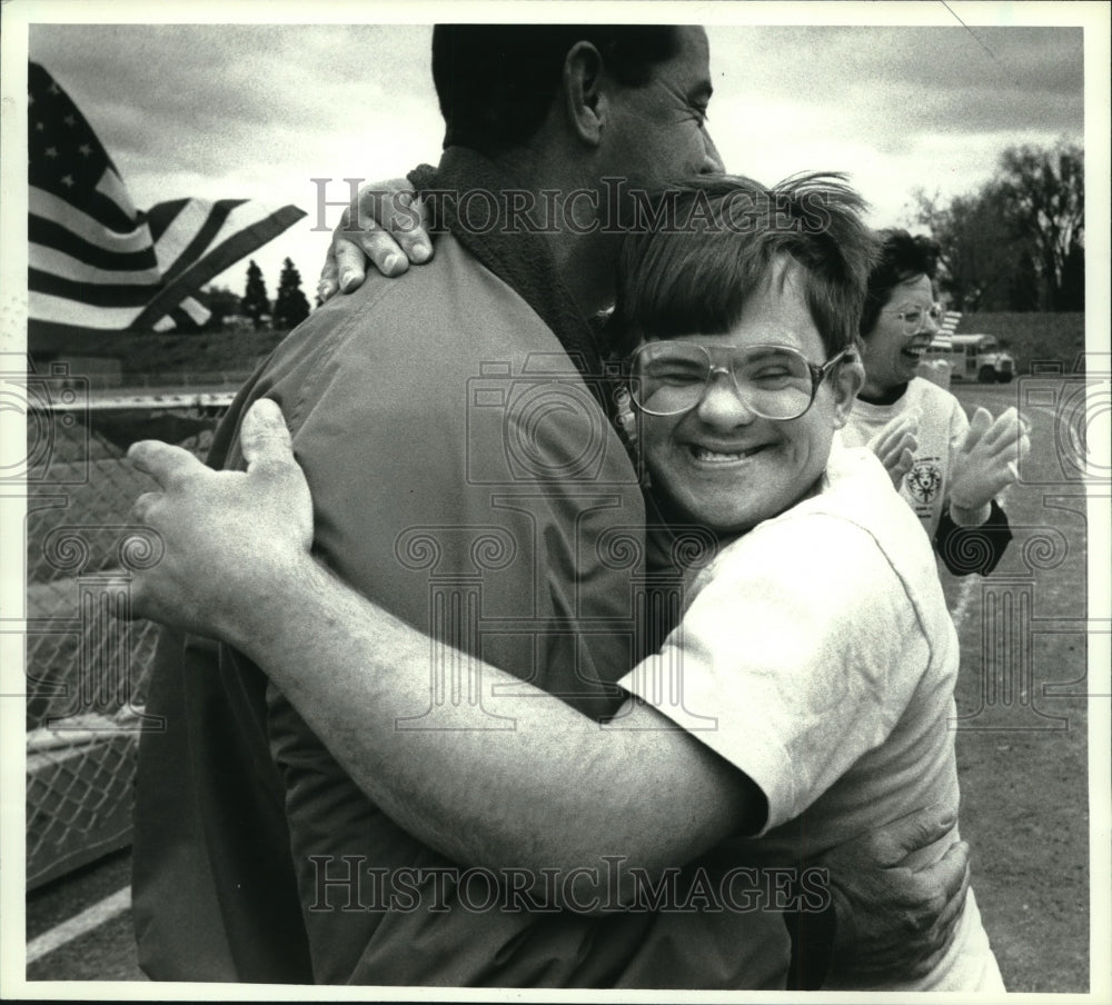 1990 Press Photo Special Olympian hugs fan after winning race in Albany, NY- Historic Images