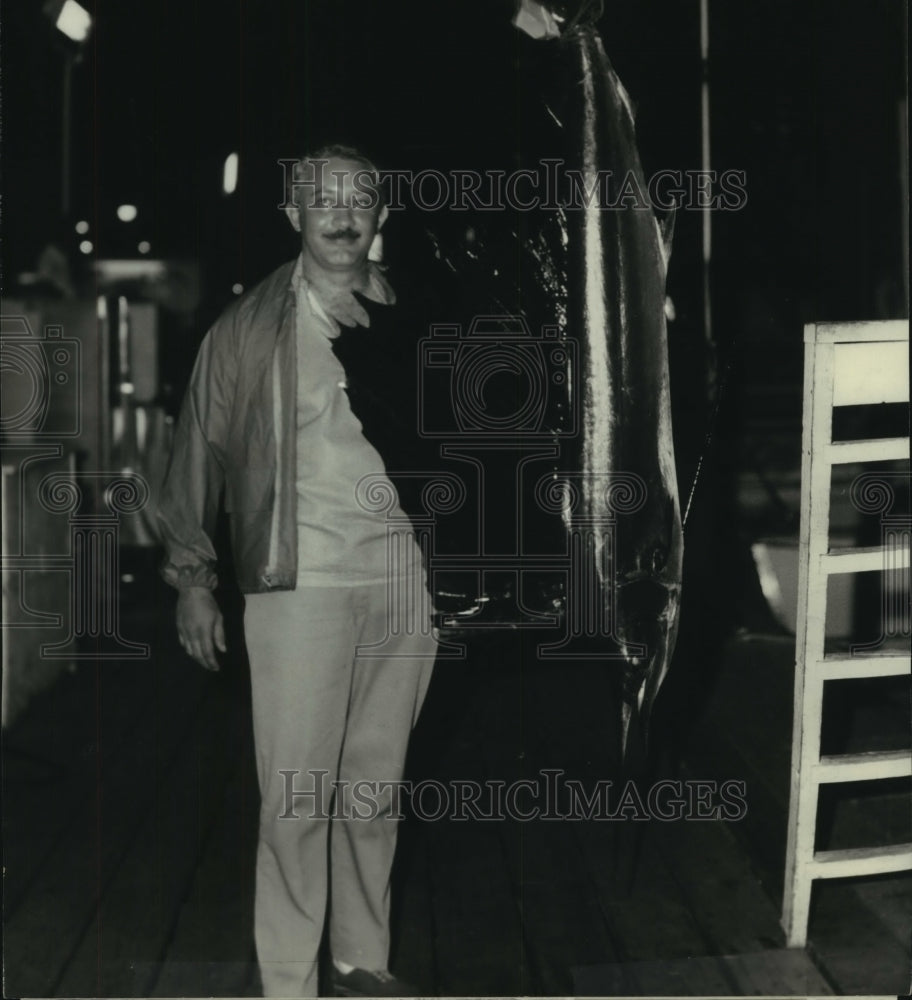 1978 Press Photo Dr James Murphy happily stands next to large fish on dock- Historic Images