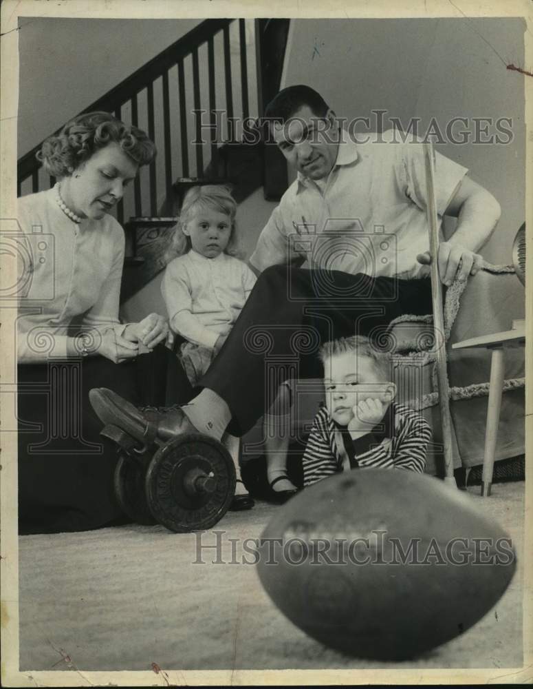 1960 Press Photo Mrs. Ernie Stautner straps weights on husband football star, NY- Historic Images