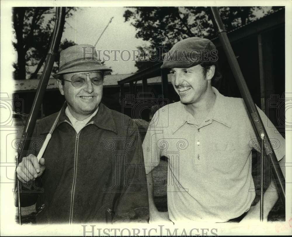 Press Photo Roy Simser (left) and his son Perry smile for photo at horse track- Historic Images