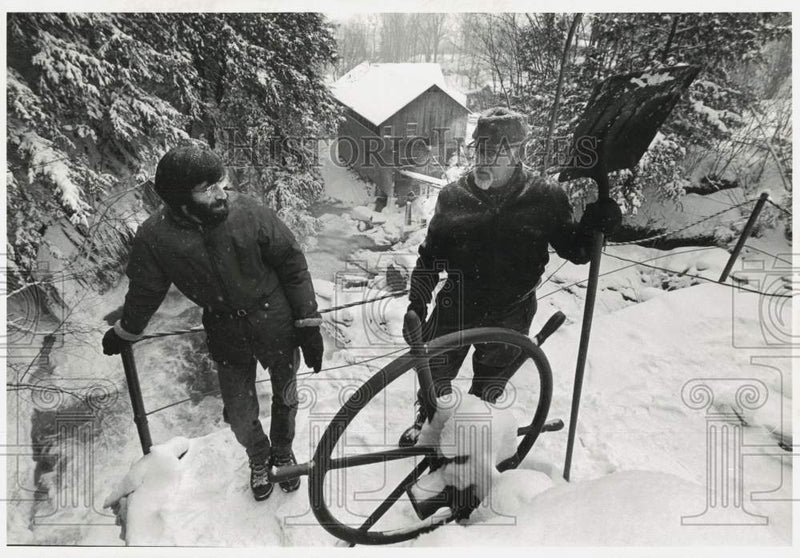 Load image into Gallery viewer, 1978 Press Photo Peter and Joel Tourin at Snow Covered Boat Wheel - tuw06708
