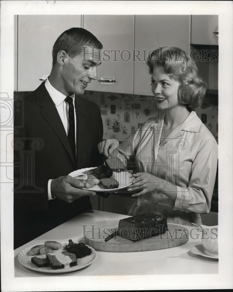 Press Photo Unknown Couple Serving Dinner - nem34882 - Historic Images