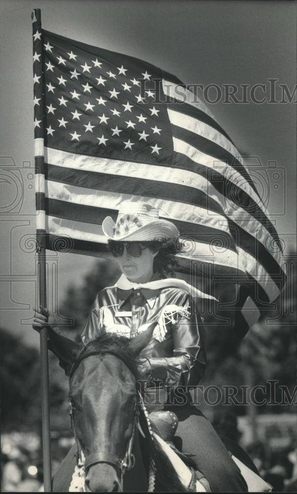 1983 Press Photo Rider on horse with flag; Fourth of July parade, Wisconsin - Historic Images