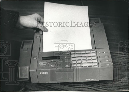 1989 Press Photo Person Holding a Piece of Paper to the Fax Machine - mjb04517 - Historic Images