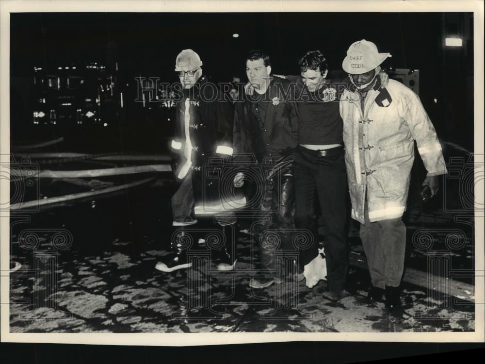 1988 Press Photo Milwaukee Firefighters Help Injured Man - mjb17996 - Historic Images