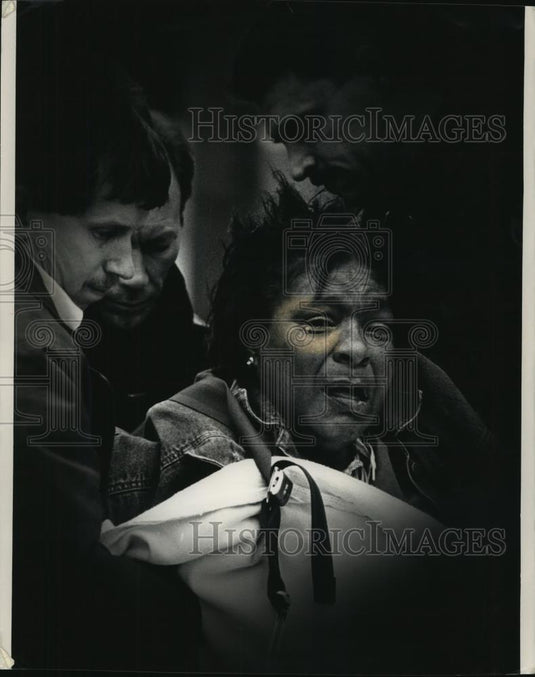 1991 Press Photo Rescue personnel help apartment resident after Milwaukee fire - Historic Images