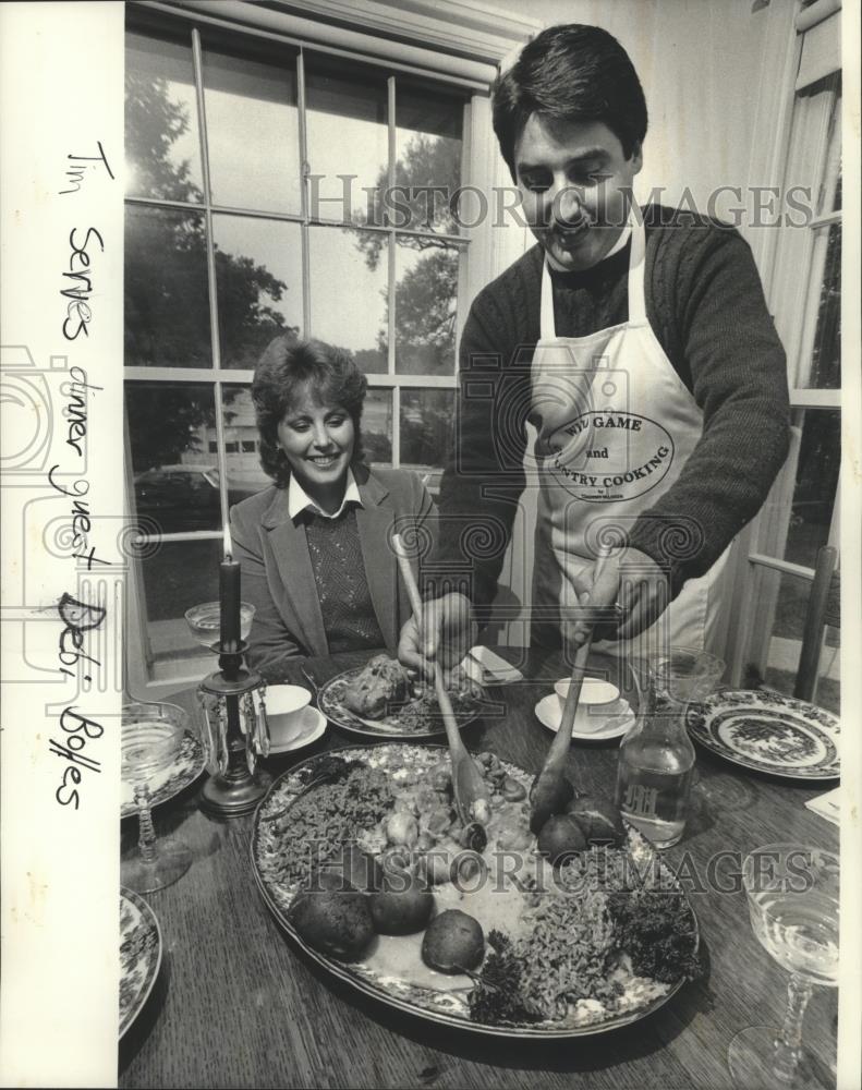 1983 Press Photo Cookbook author Timothy Manion serves dinner to Debi Bolles - Historic Images