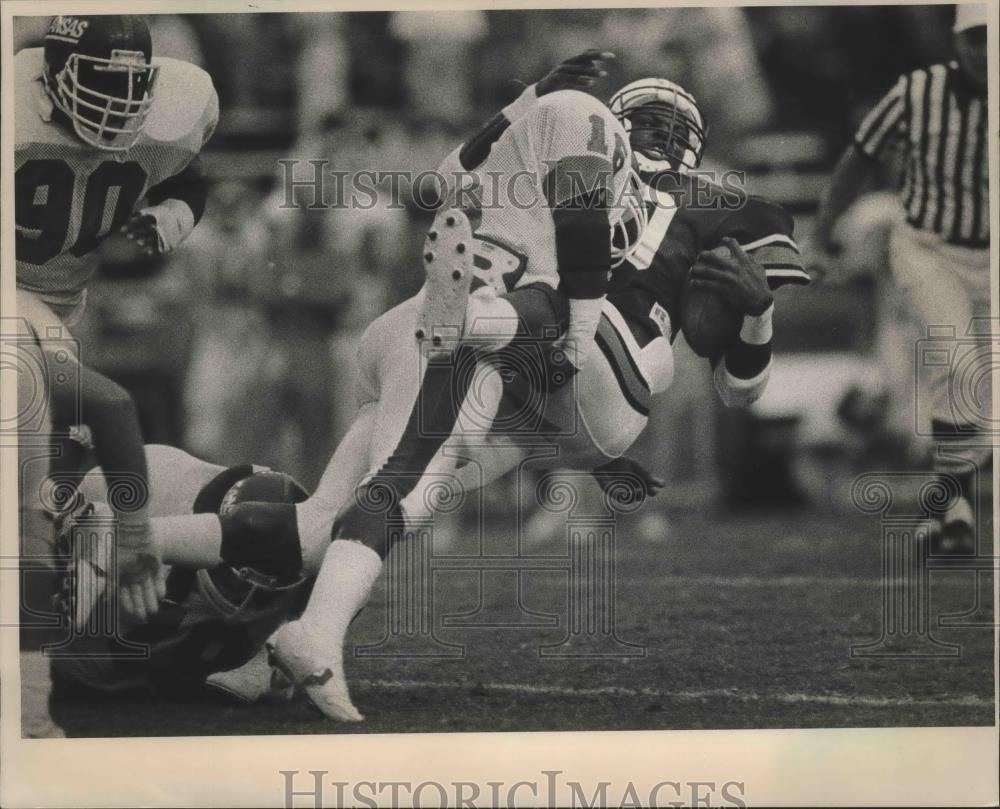 Press Photo Auburn Player With Football Is Upended By Vigorous Kansas Tackler - Historic Images