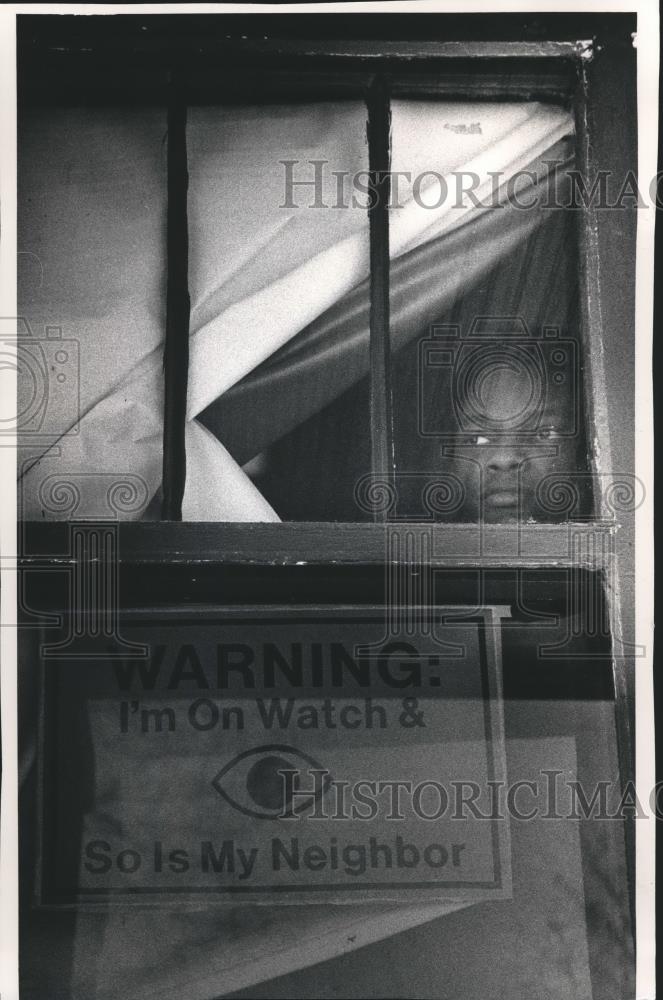 1991 Press Photo Young man at the window in Milwaukee, Wisconsin. - mjb51575 - Historic Images