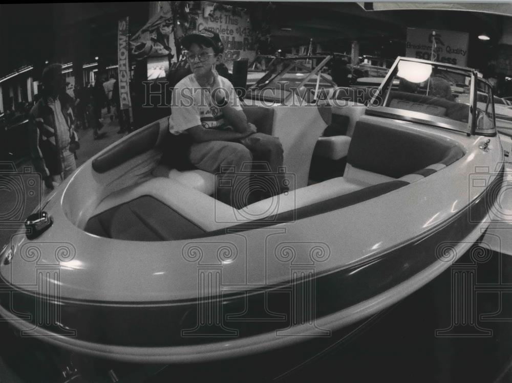 1994 Press Photo Lucas Conmey sitting in a boat at Milwaukee Boat Show - Historic Images