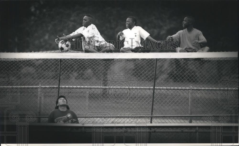 1993 Press Photo Boys help David Hernandez get soccer ball in Washington Park - Historic Images
