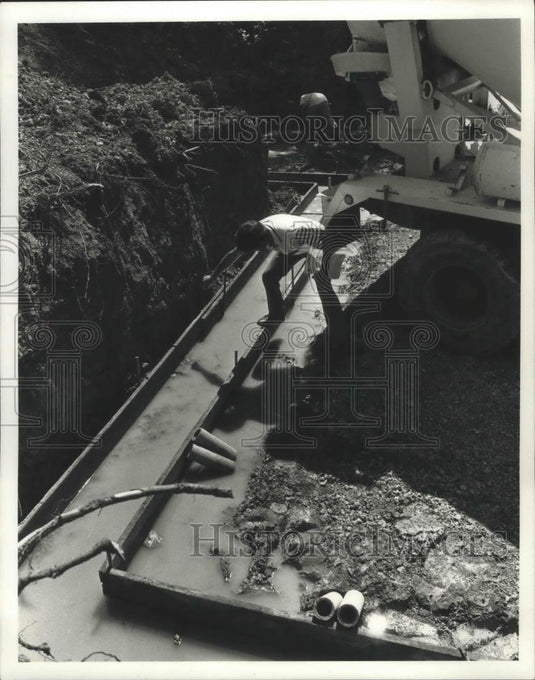 1990 Press Photo Gygax inspects concrete forms of foundation of home New Berlin - Historic Images