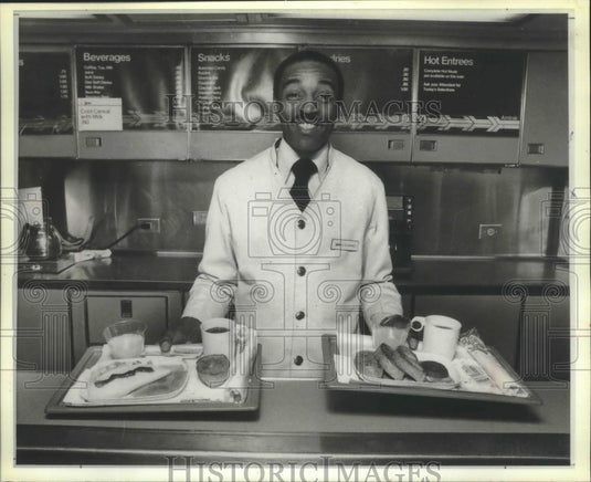 1990 Press Photo Edward Baines shows part of breakfast menu on train - Historic Images