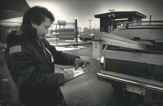 1990 Press Photo Hmong security guard Vang T. Xion checks receipt Waukesha - Historic Images