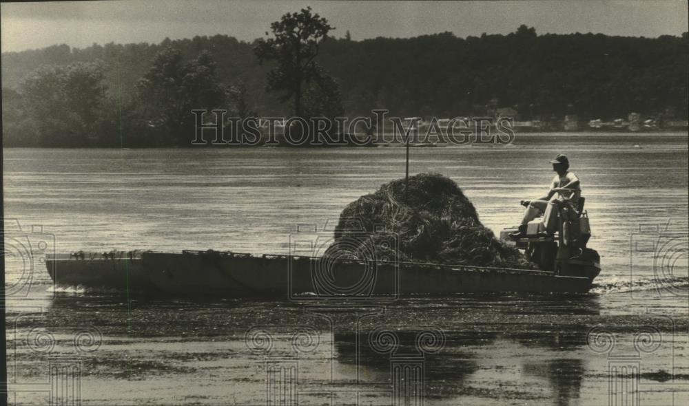 Press Photo Boat with large pile of weeds from Pewaukee Lake Wisconsin - Historic Images