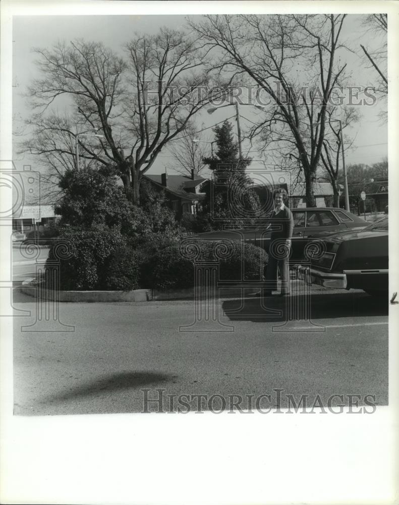 Man stands next to a car on parking lot in Sylacauga, Alabama, 1980