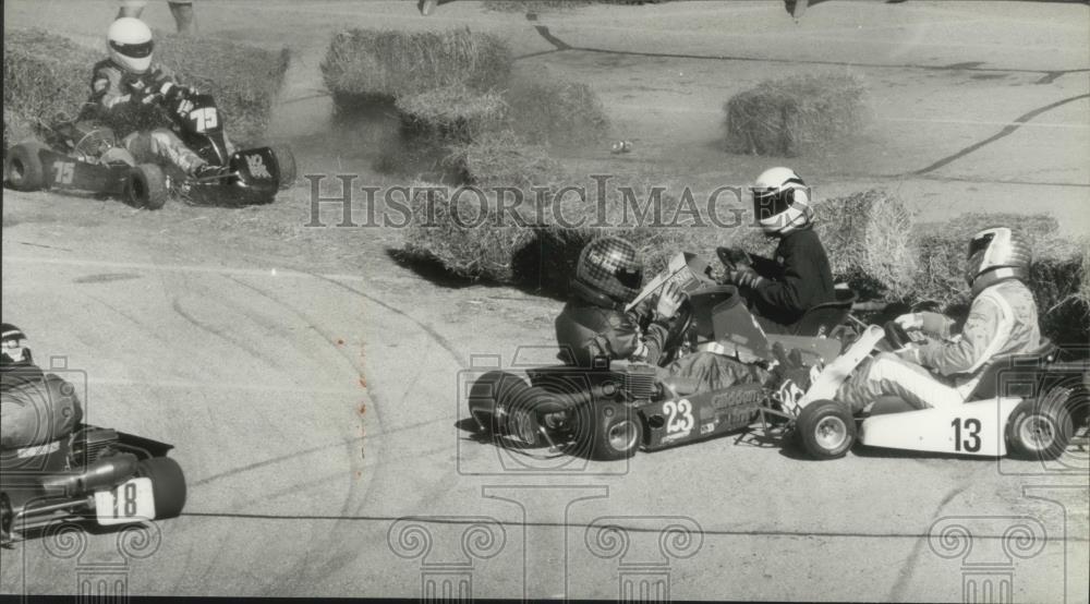 1994 Press Photo Straw bales fly when an accident sends 4 karts into the wall. - Historic Images
